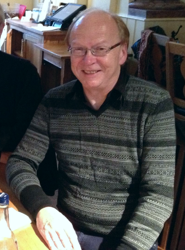 Portrait of Robert Orledge seated at home